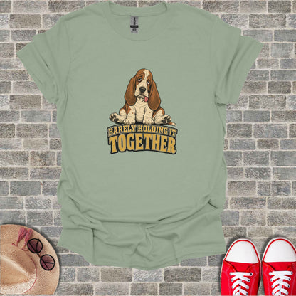 Basset hound in vintage style with text "BARELY HOLDING IT TOGETHER".