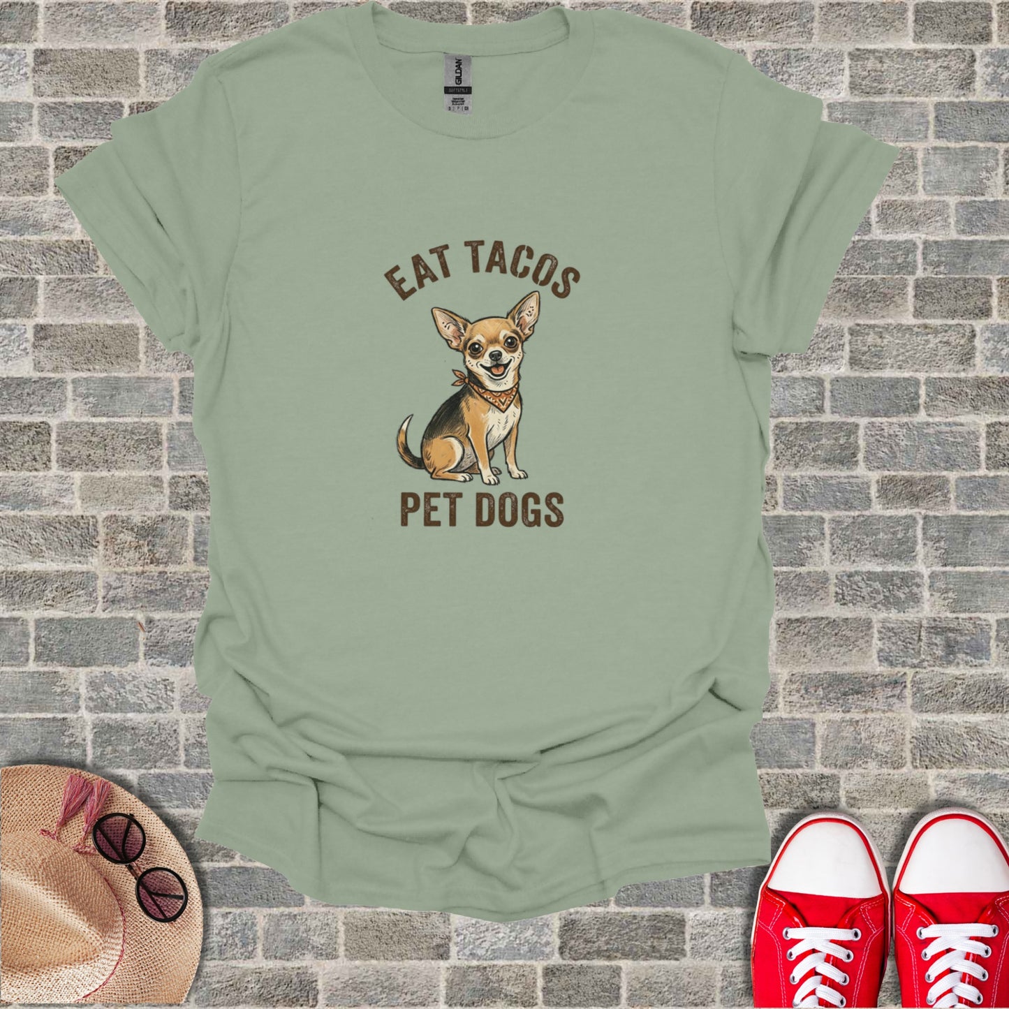 Green t-shirt with cartoon chihuahua saying "Eat Tacos Pet Dogs".