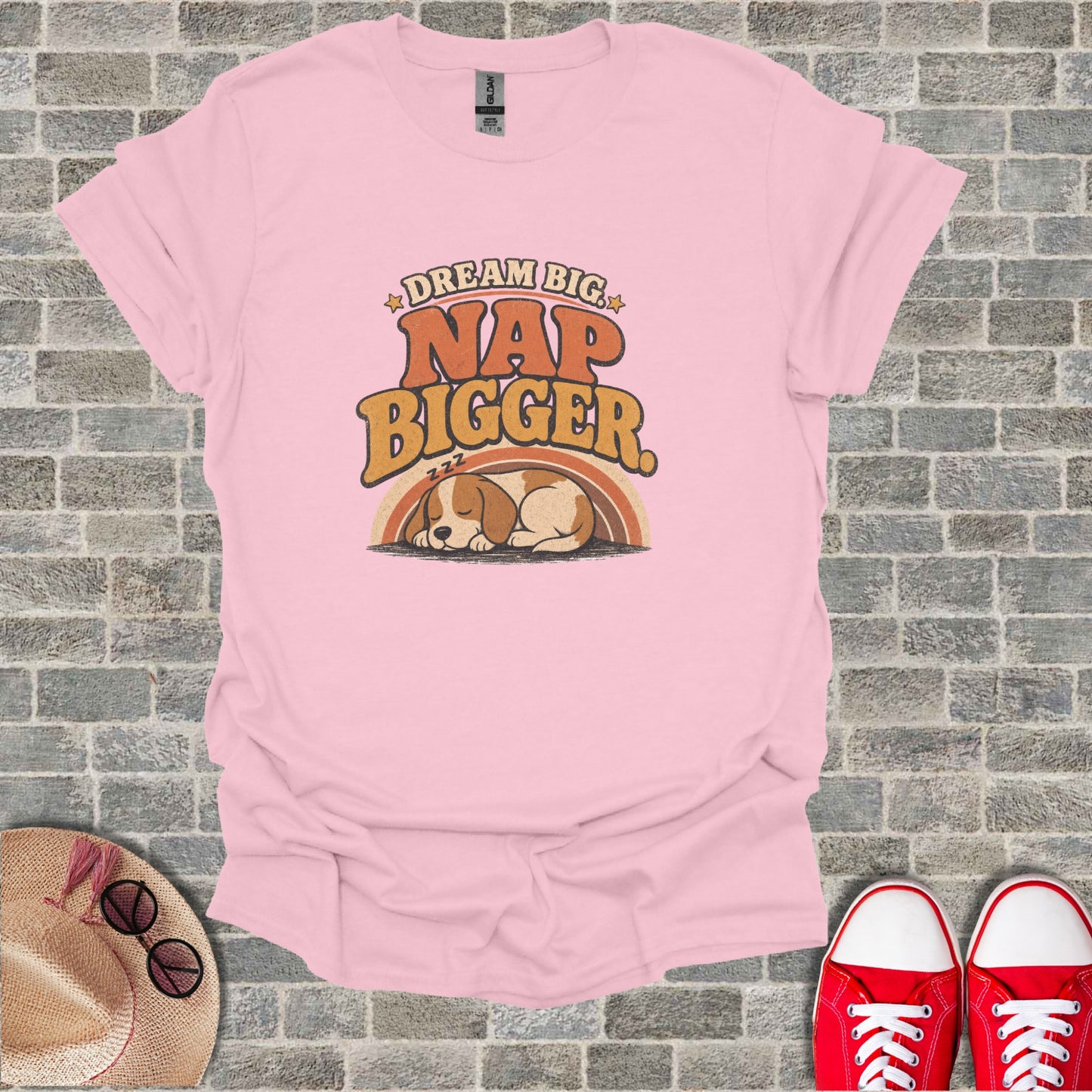 Pink t-shirt with "Dream Big Nap Bigger" text and sleeping dog graphic.