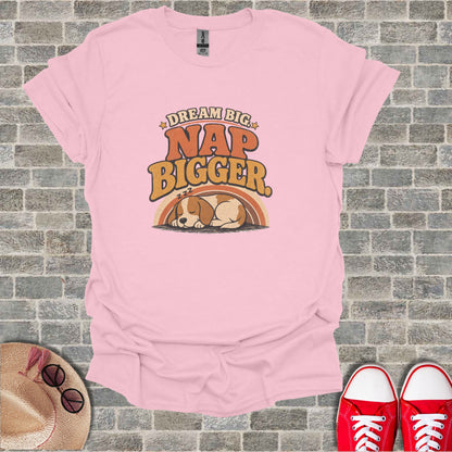 Pink t-shirt with "Dream Big Nap Bigger" text and sleeping dog graphic.