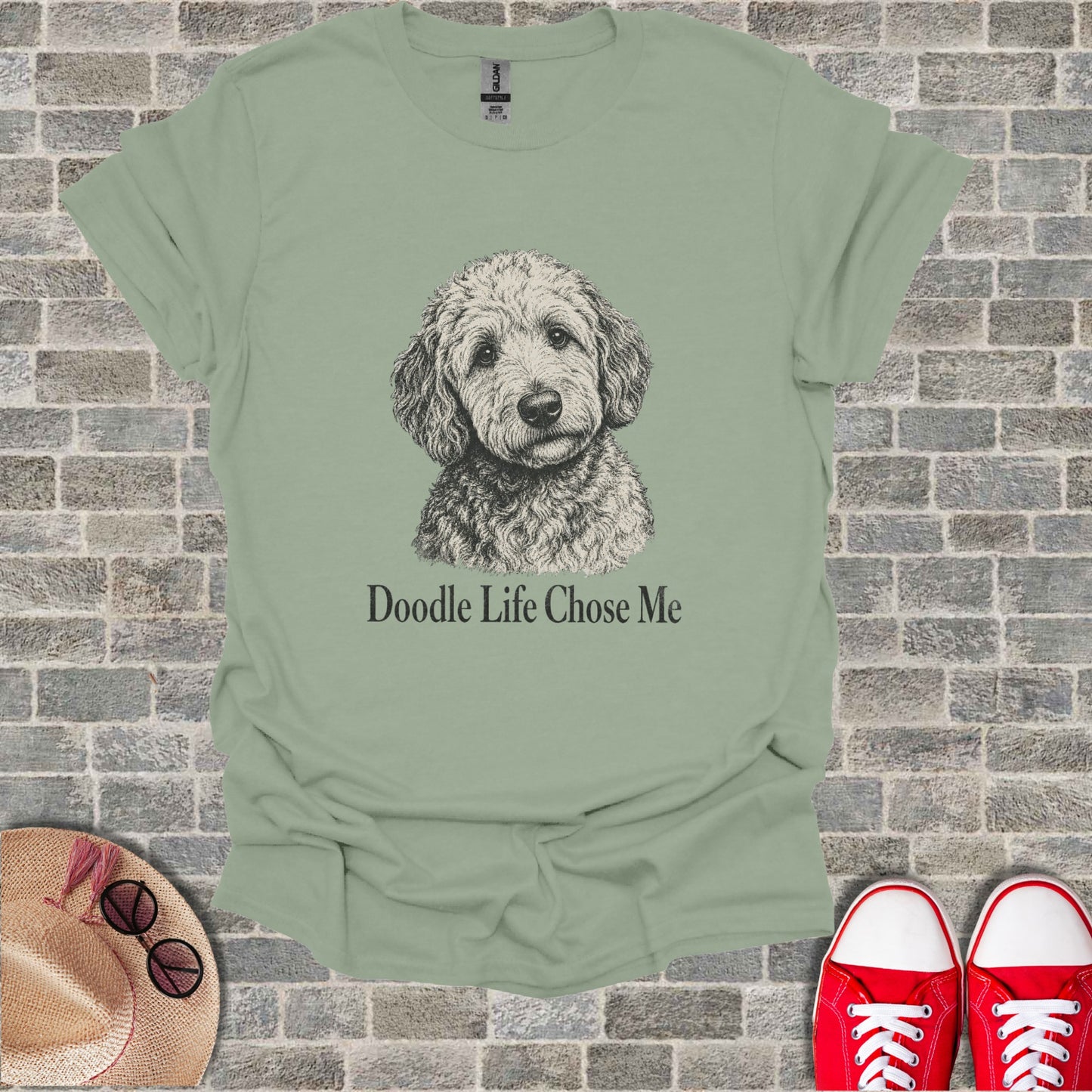 Light green t-shirt with sketch of dog and text.