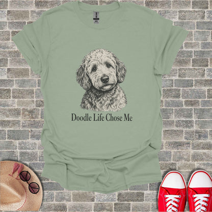Light green t-shirt with sketch of dog and text.