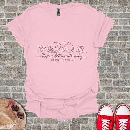 Pink t-shirt with sleeping dog line art and text "Life is better with a dog OR TWO, OR THREE..."