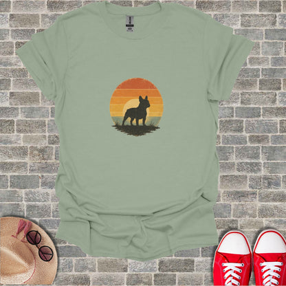 French bulldog silhouette against a sunset on a light green t-shirt.