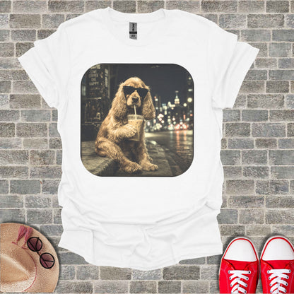 White t-shirt with a graphic of a dog wearing sunglasses drinking iced coffee.