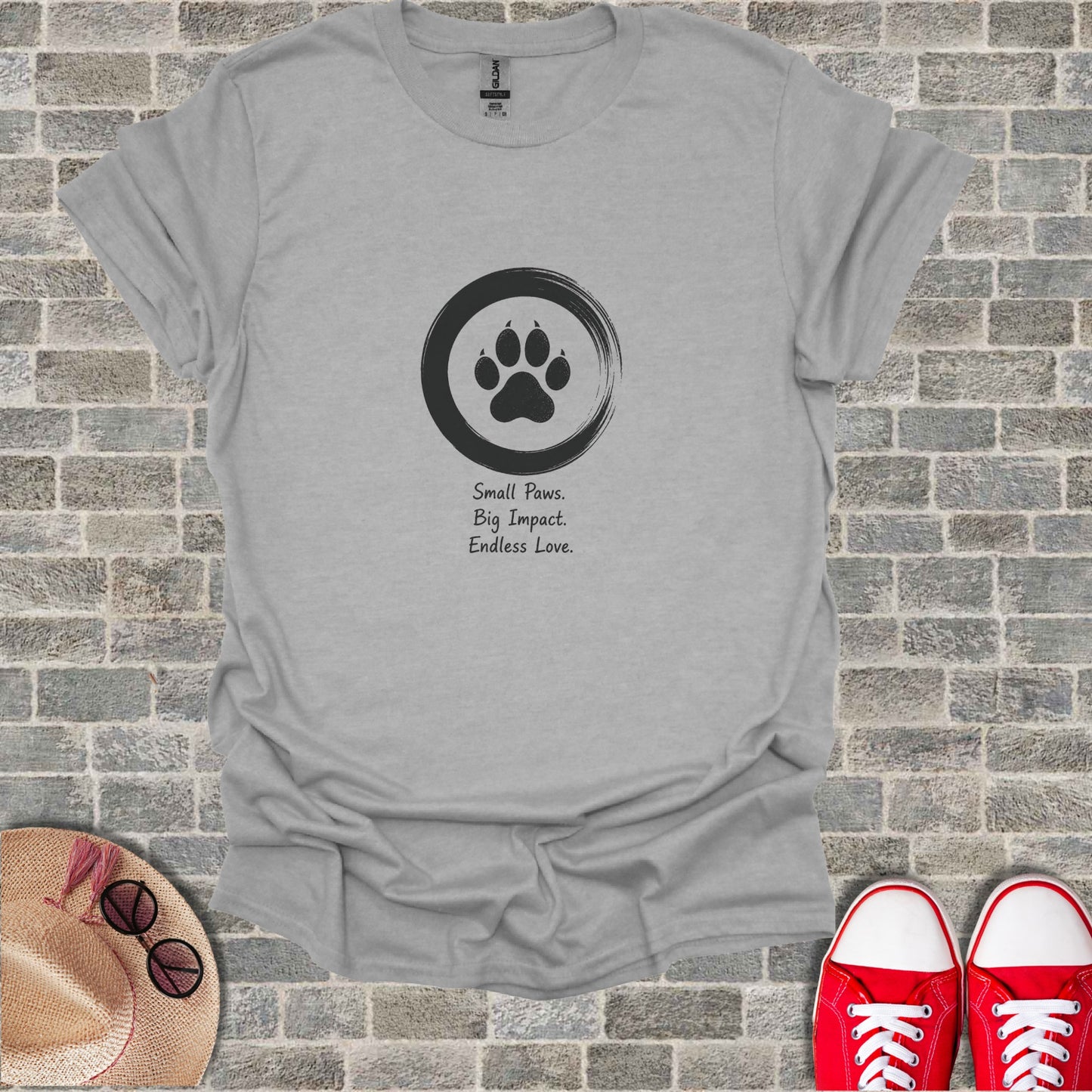 Gray t-shirt with a paw print logo and the text "Small Paws. Big Impact. Endless Love."