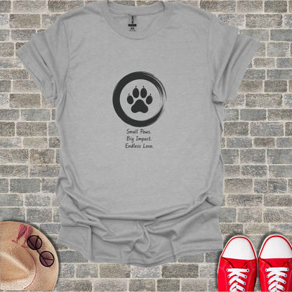 Gray t-shirt with a paw print logo and the text "Small Paws. Big Impact. Endless Love."