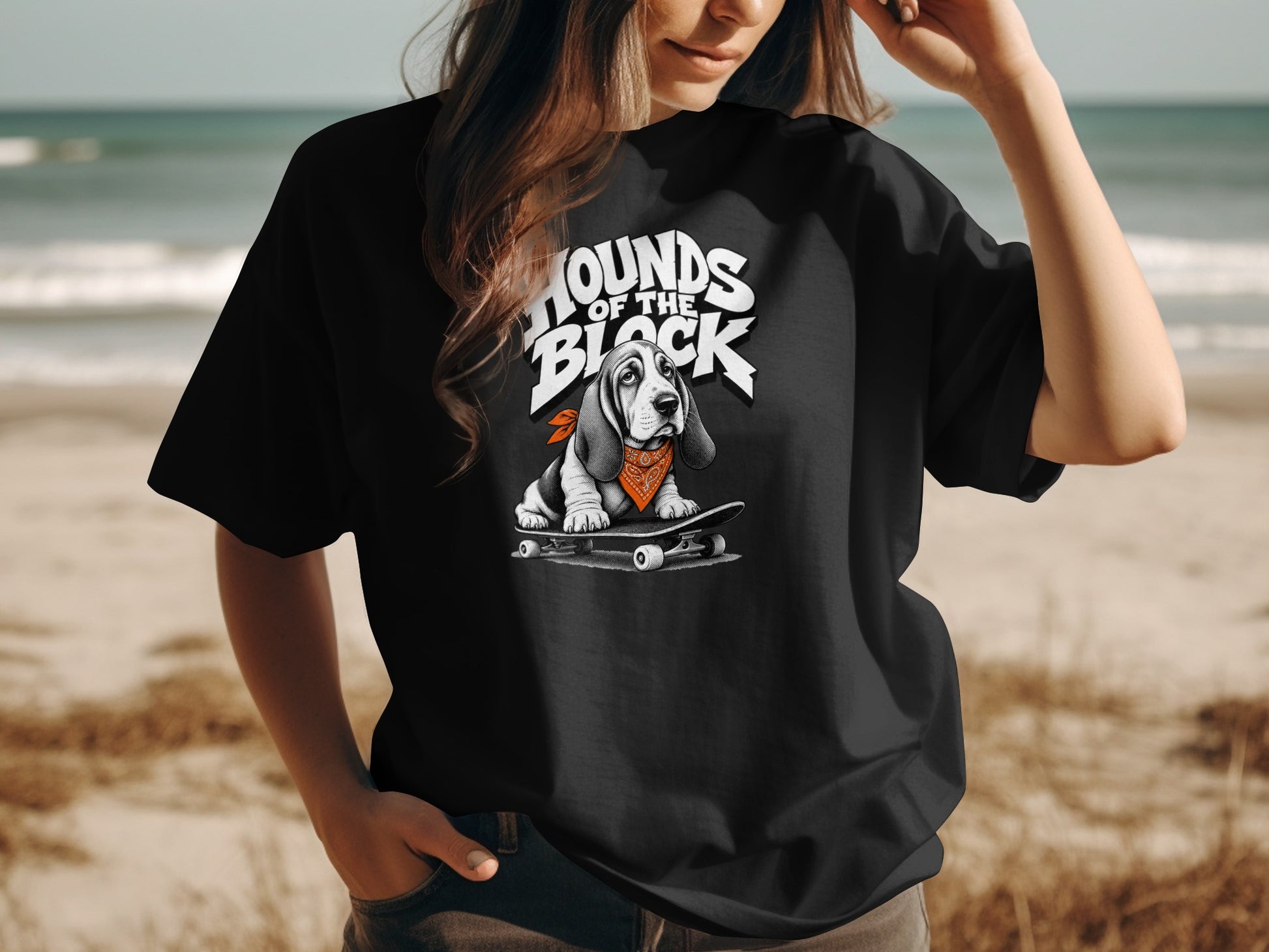Black t-shirt with a basset hound wearing a bandana on a skateboard.
