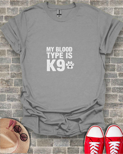 Gray t-shirt with "MY BLOOD TYPE IS K9" text and paw print.