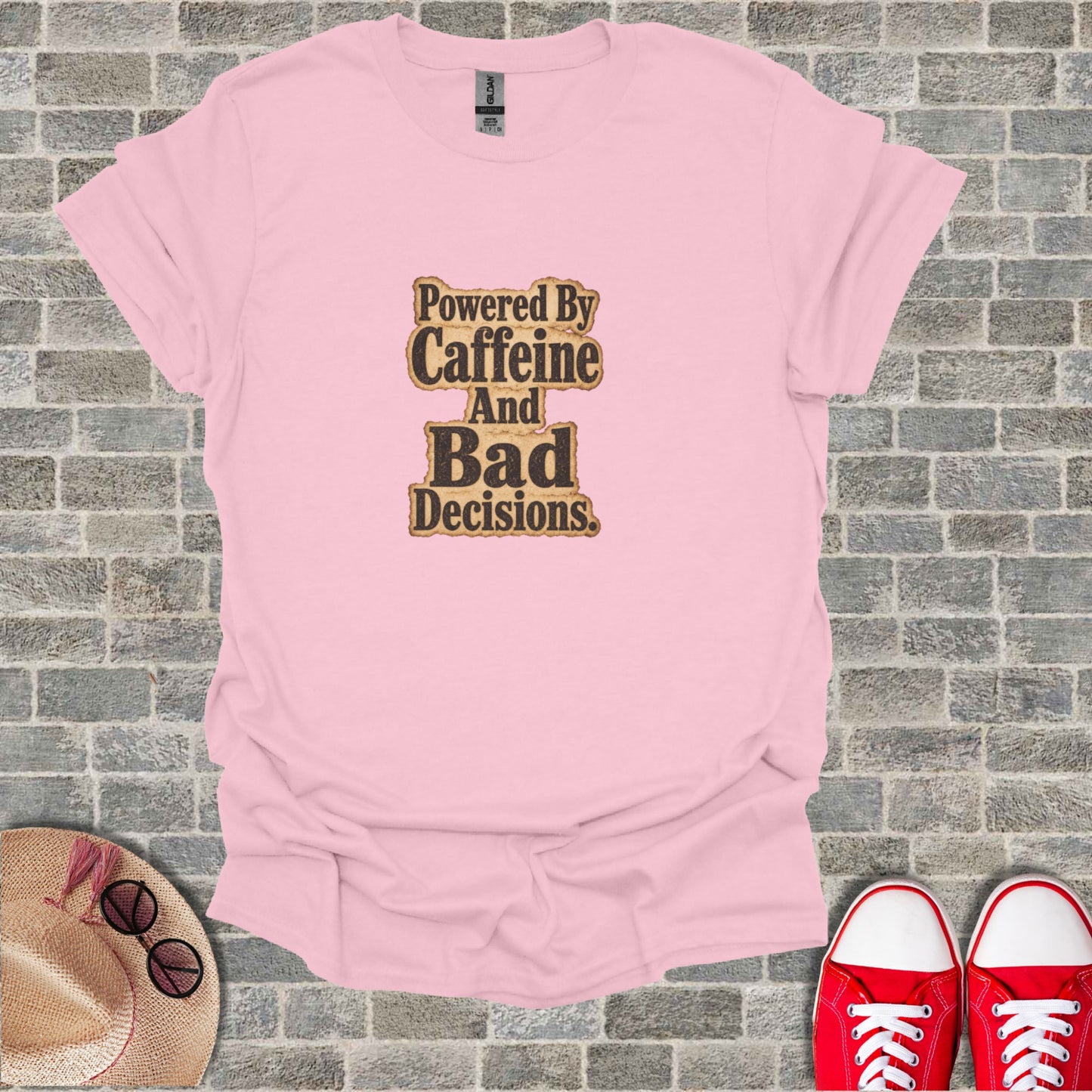 Pink t-shirt with "Powered By Caffeine And Bad Decisions" text.