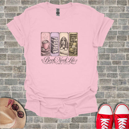 Pink t-shirt with "Book Nook Life" design featuring a mug, books, and armchair.