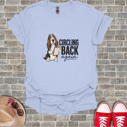 Basset hound holding a clipboard with "CIRCLING BACK again" text.