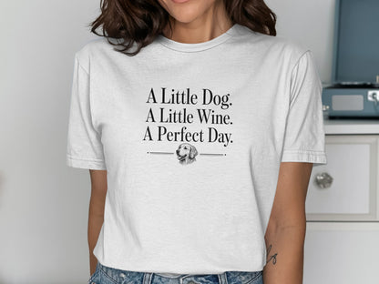 White t-shirt with text "A Little Dog. A Little Wine. A Perfect Day." and dog graphic.