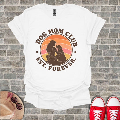 White t-shirt with "DOG MOM CLUB EST. FUREVER" graphic featuring a woman and dog.