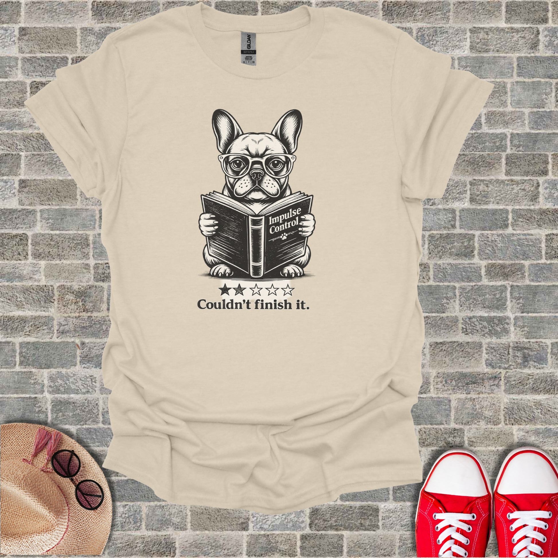 French bulldog wearing glasses reads a book with "Impulse Control" text.