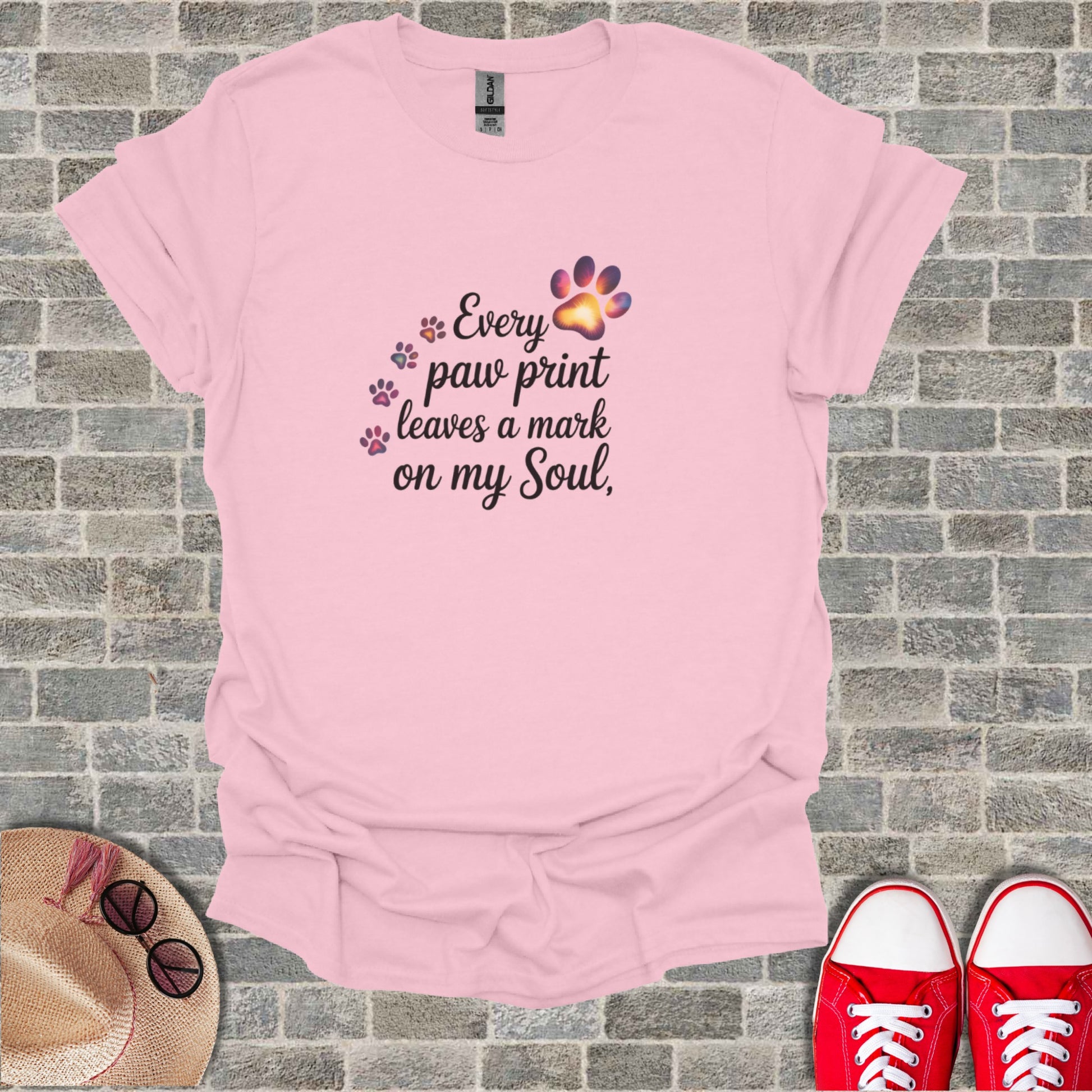 Pink t-shirt with "Every paw print leaves a mark on my Soul" text and paw prints.