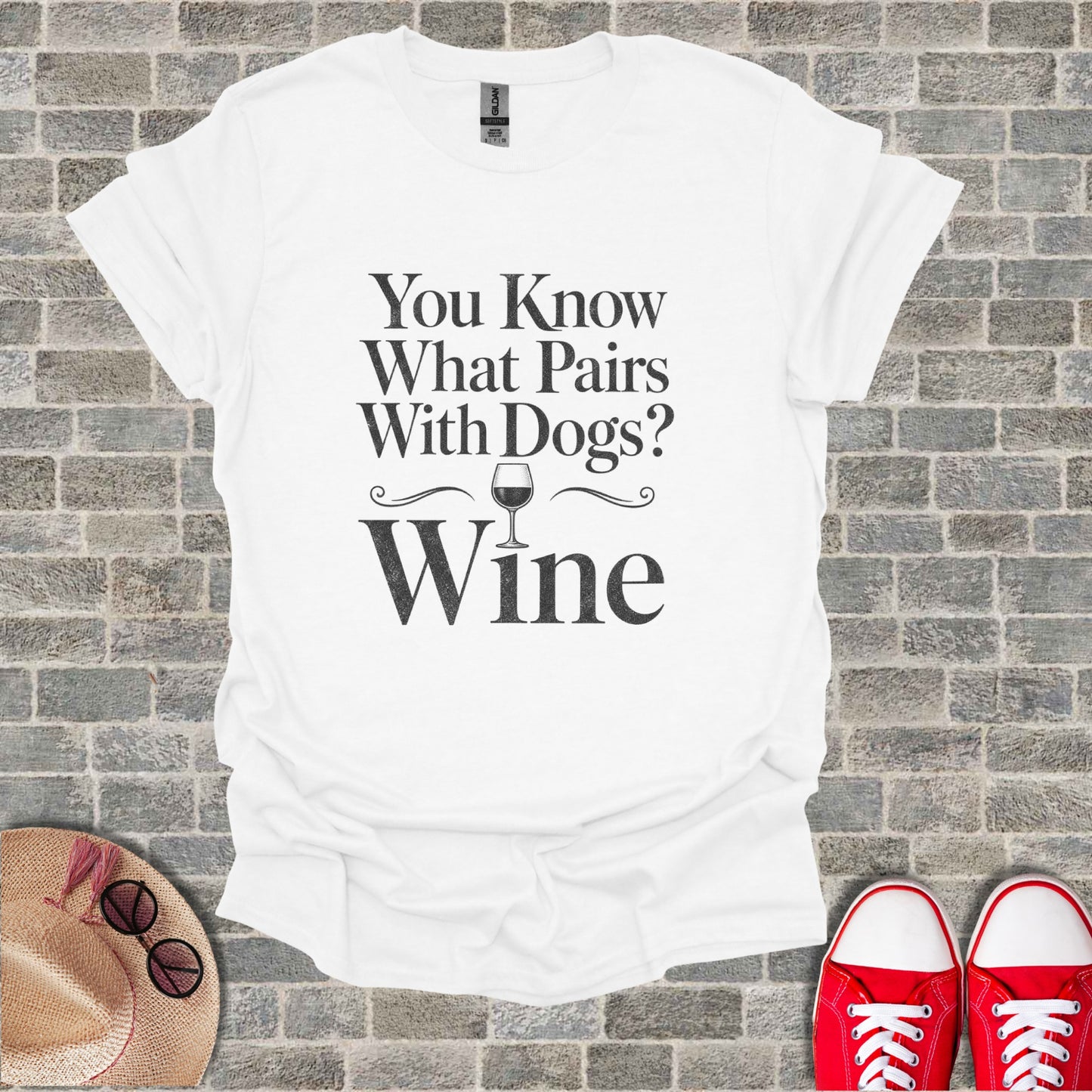 White t-shirt with black text that reads "You Know What Pairs With Dogs? Wine".