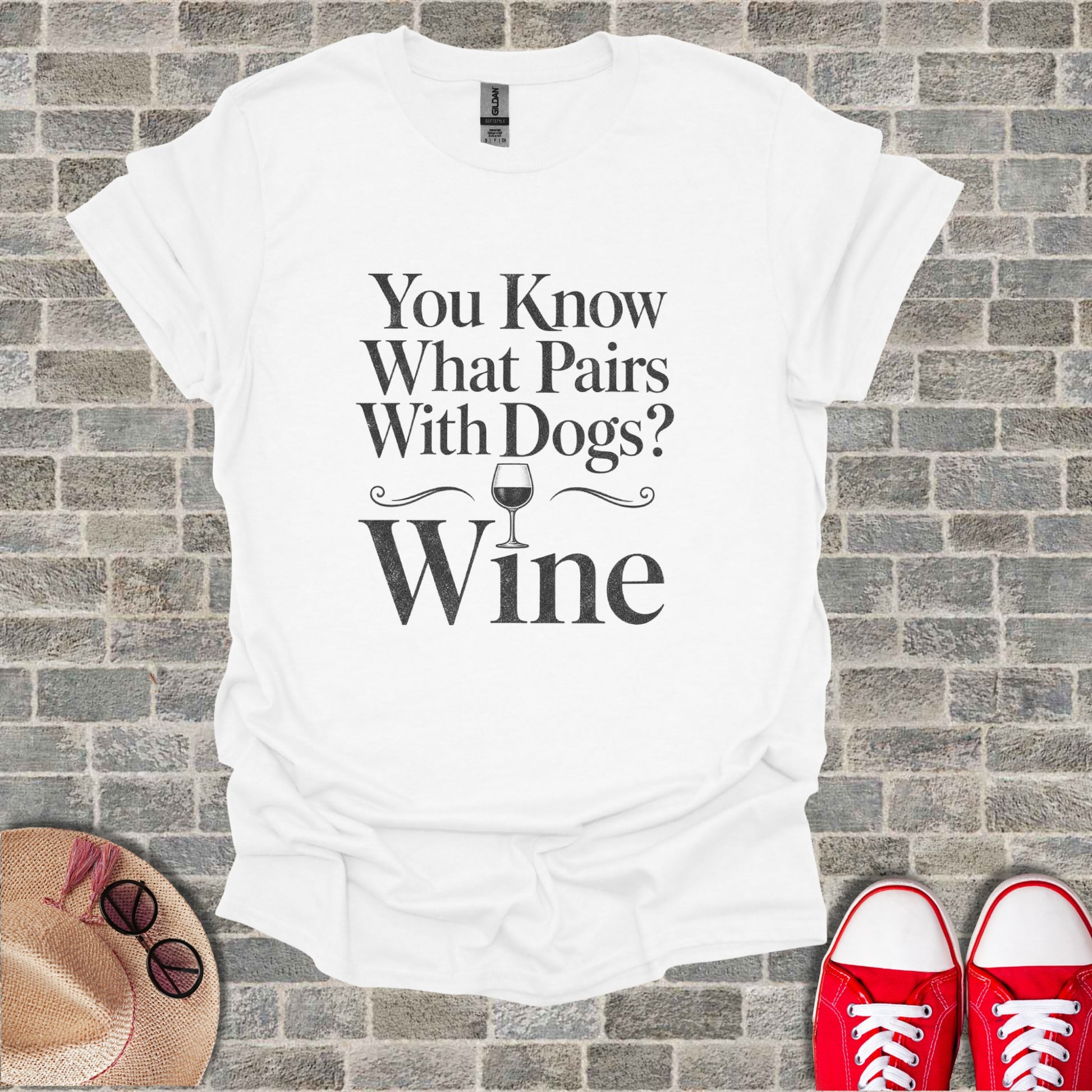 White t-shirt with black text that reads "You Know What Pairs With Dogs? Wine".