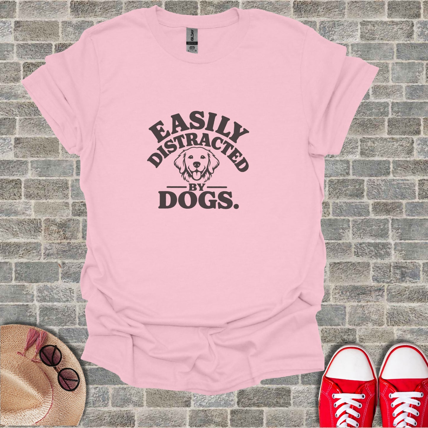 Pink t-shirt with "Easily Distracted by Dogs." text and dog silhouette.