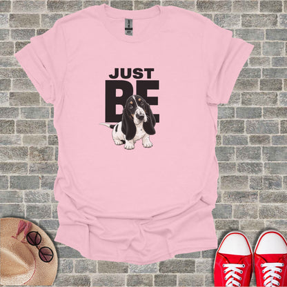 Pink t-shirt with black and white Basset Hound and "JUST BE" text.
