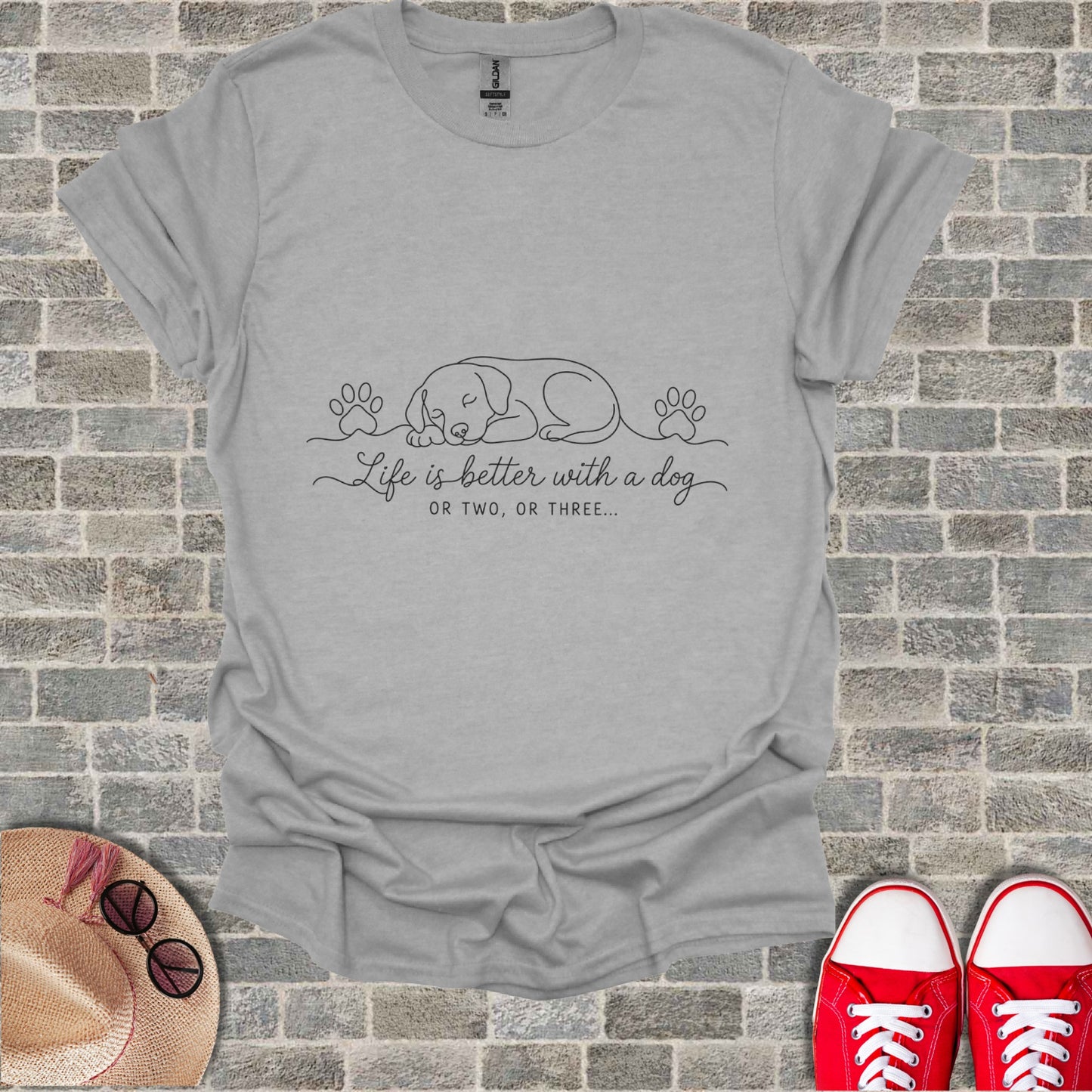 Gray t-shirt with sleeping dog and paw print graphic and text.