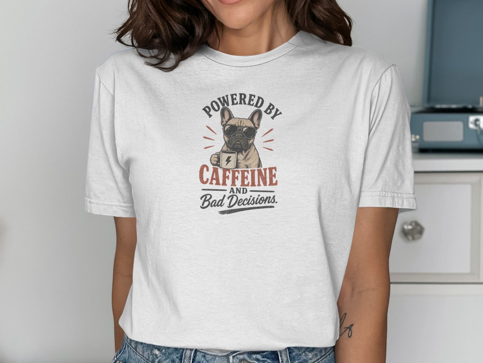 French bulldog wearing sunglasses holds coffee cup, "Powered by Caffeine and Bad Decisions" text.