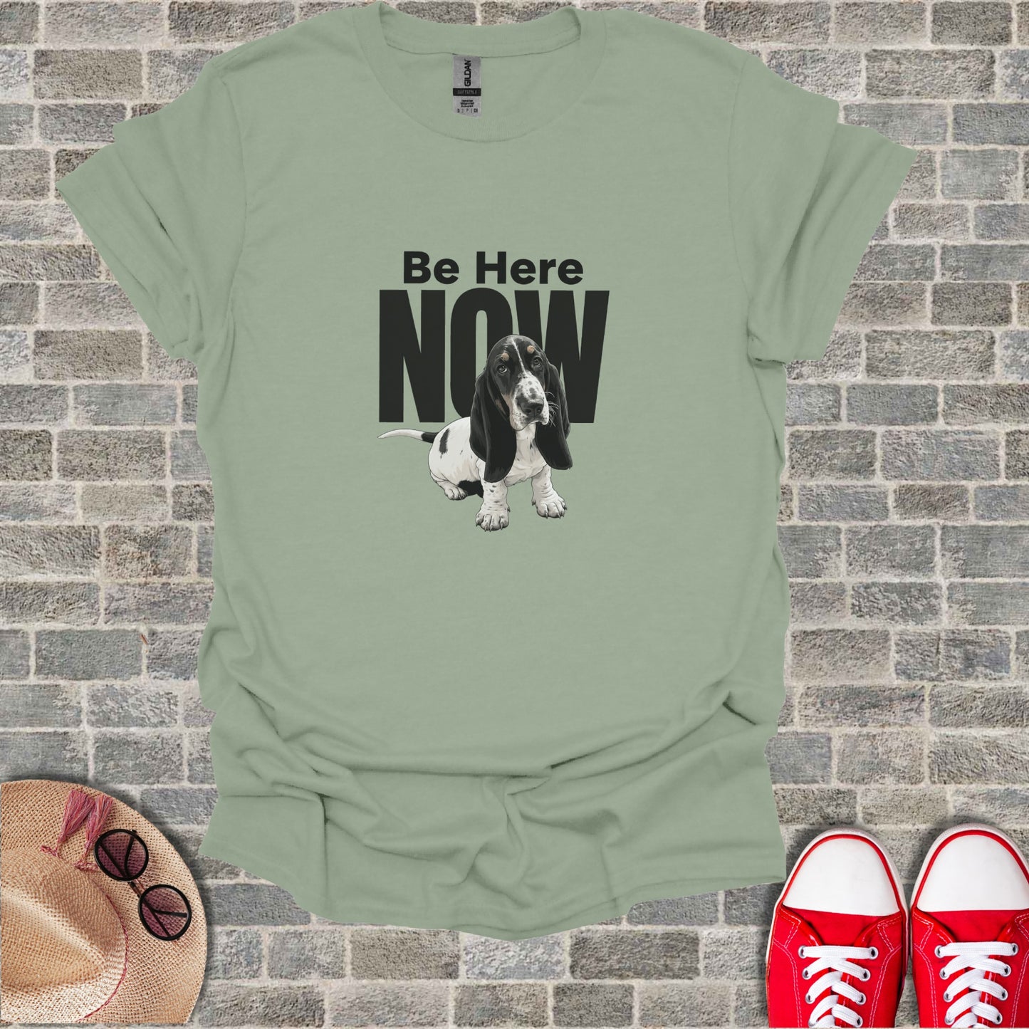 Sage green t-shirt with a Basset Hound and "Be Here Now" text.