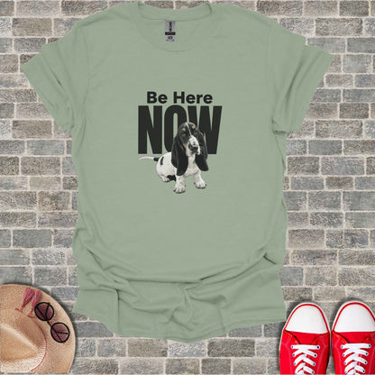 Sage green t-shirt with a Basset Hound and "Be Here Now" text.