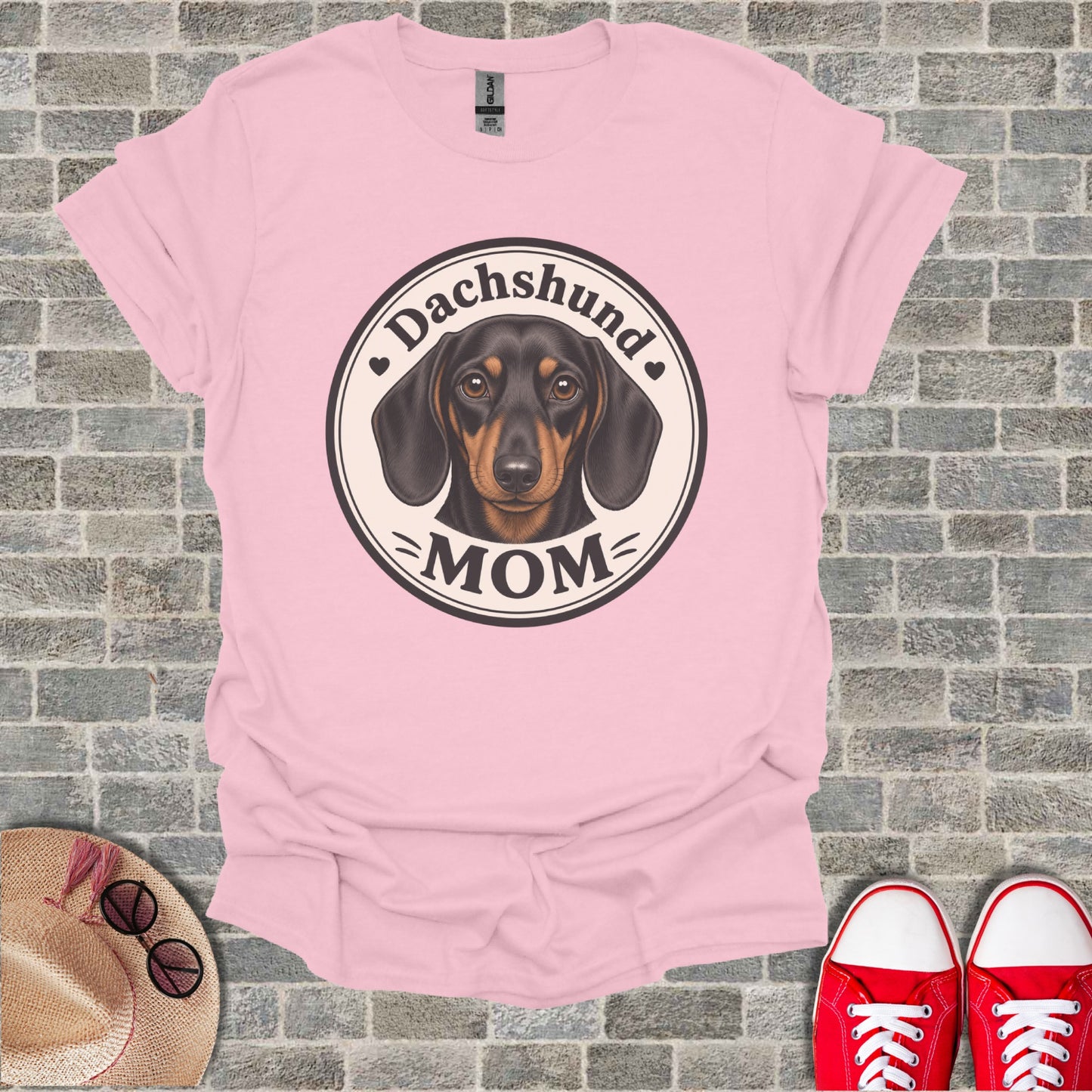 Pink t-shirt with a circular graphic of a dachshund and "Dachshund MOM" text.