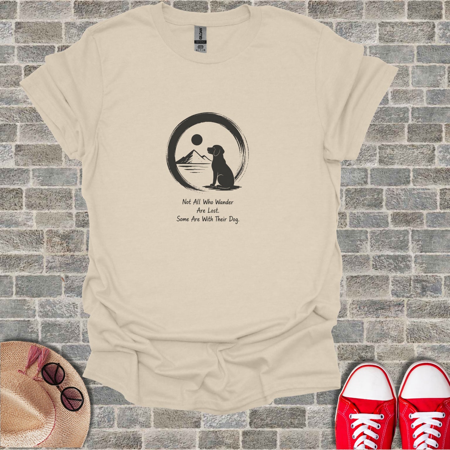 Cream t-shirt with black dog silhouette, mountains, sun, and text about dogs.