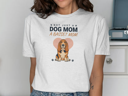 White t-shirt with "Not Just a Dog Mom, A Basset Mom" text and basset hound.