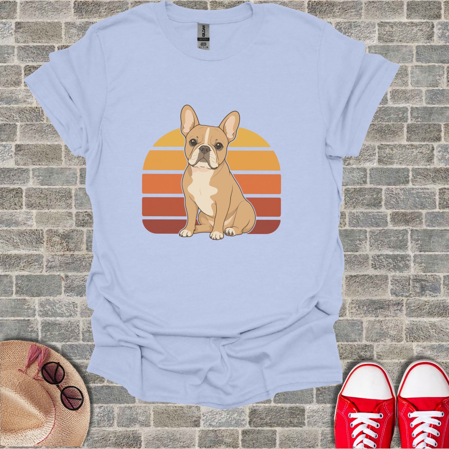 French bulldog graphic on light blue t-shirt with retro sunset design.