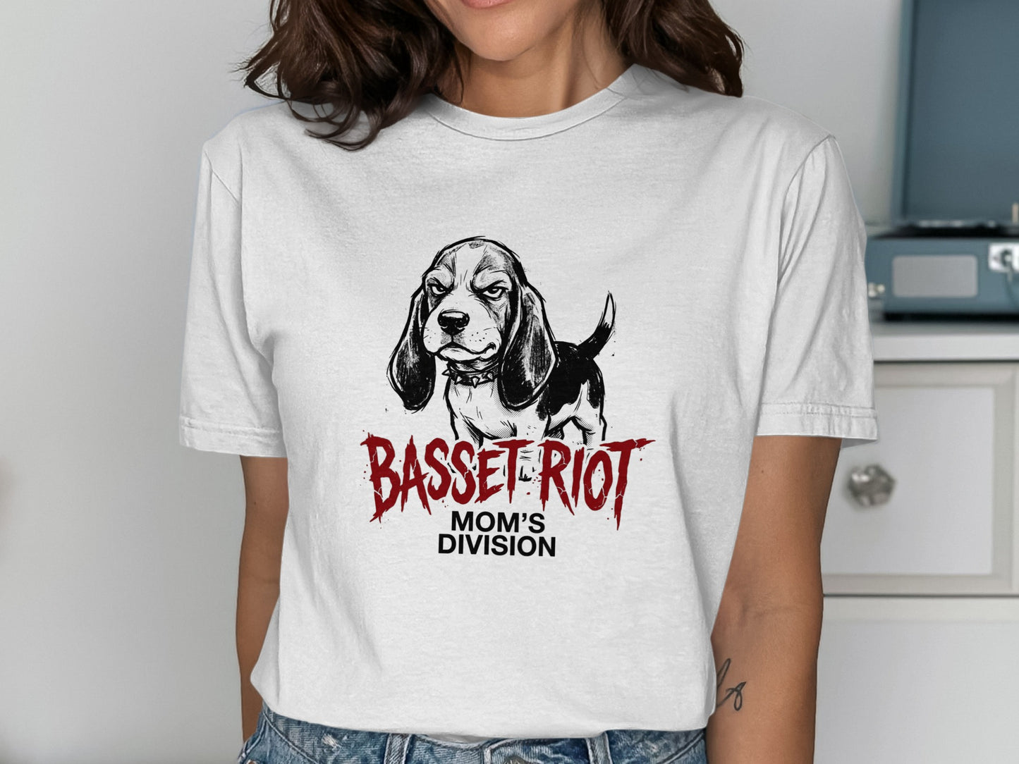 White t-shirt with a black and white basset hound illustration and "BASSET RIOT MOM'S DIVISION" text.