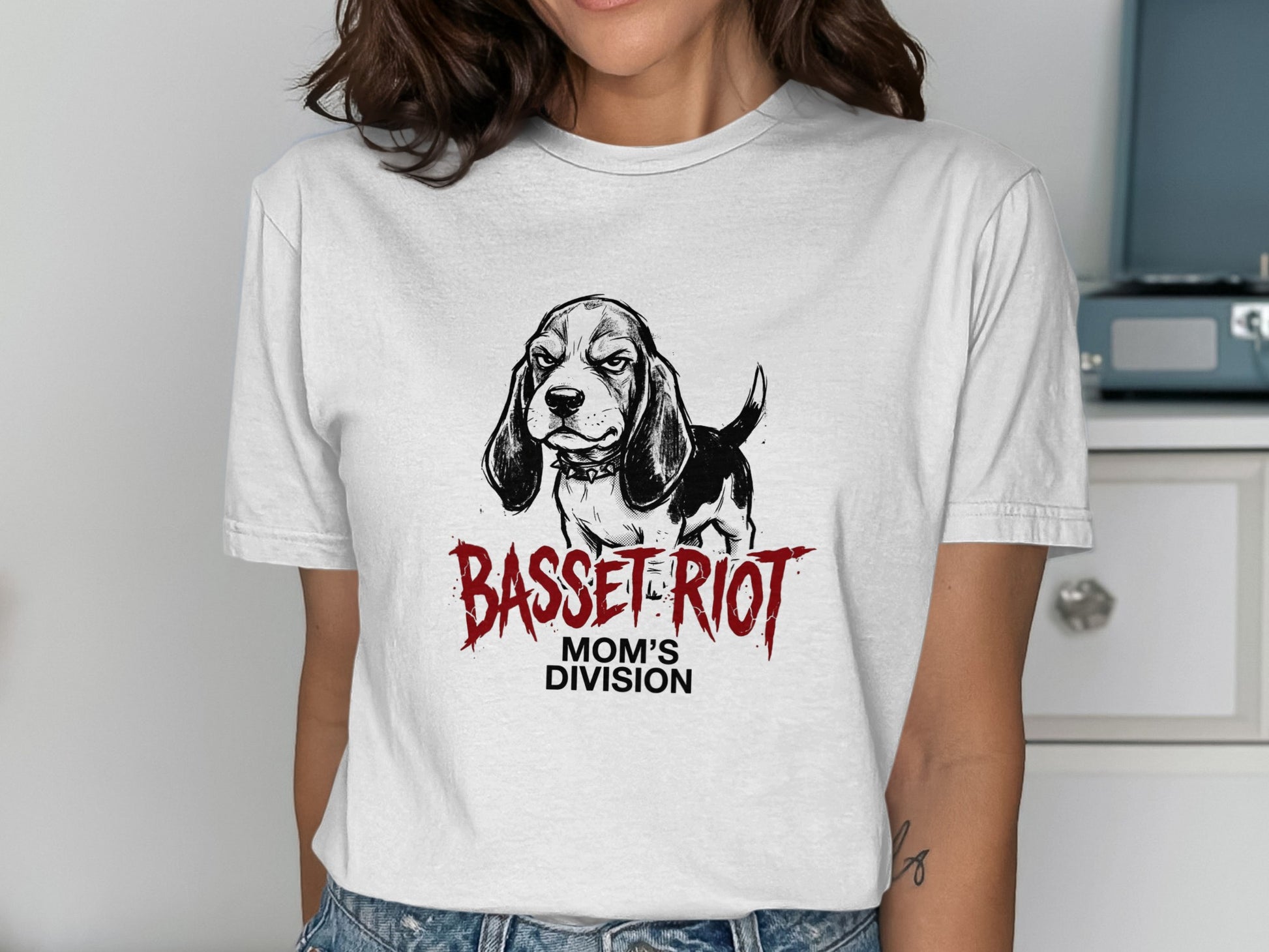 White t-shirt with a black and white basset hound illustration and "BASSET RIOT MOM'S DIVISION" text.