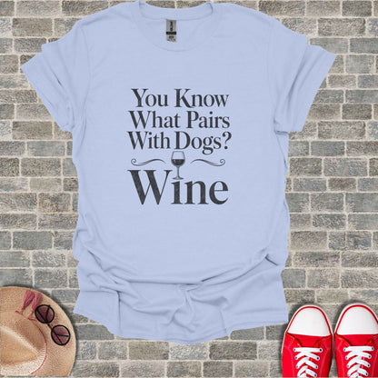 Light blue t-shirt with black text "You Know What Pairs With Dogs? Wine".
