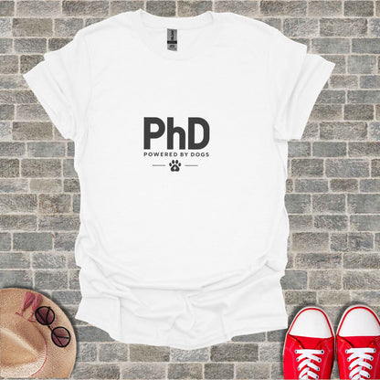 White t-shirt with "PhD POWERED BY DOGS" text and paw print.