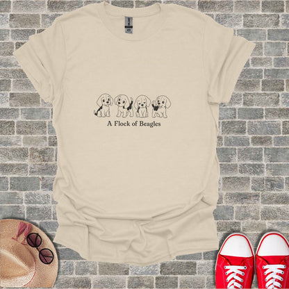 T-shirt with a line of four beagle puppies and the text "A Flock of Beagles".