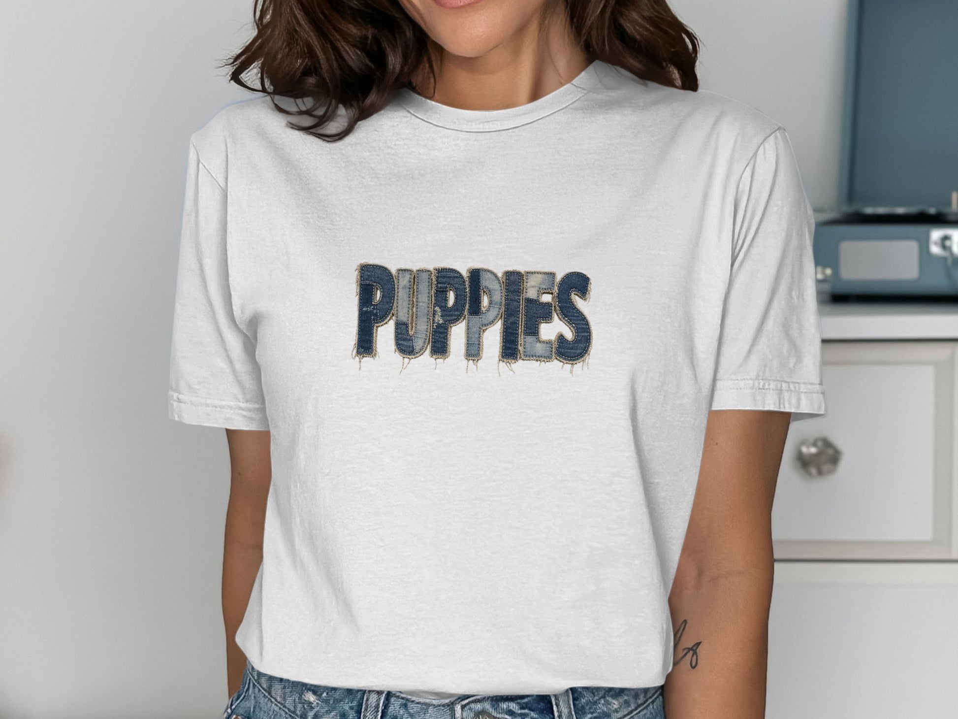 White t-shirt with "PUPPIES" in distressed denim lettering.
