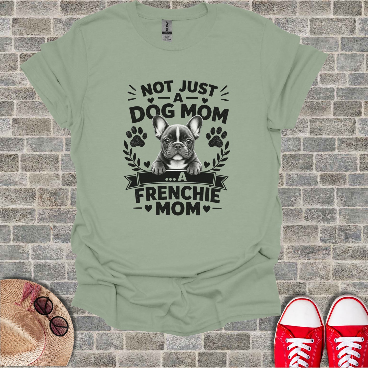 French bulldog graphic on a light green t-shirt reads "Not Just a Dog Mom... A Frenchie Mom".