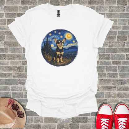 Chihuahua sits in a starry night landscape on a white t-shirt.