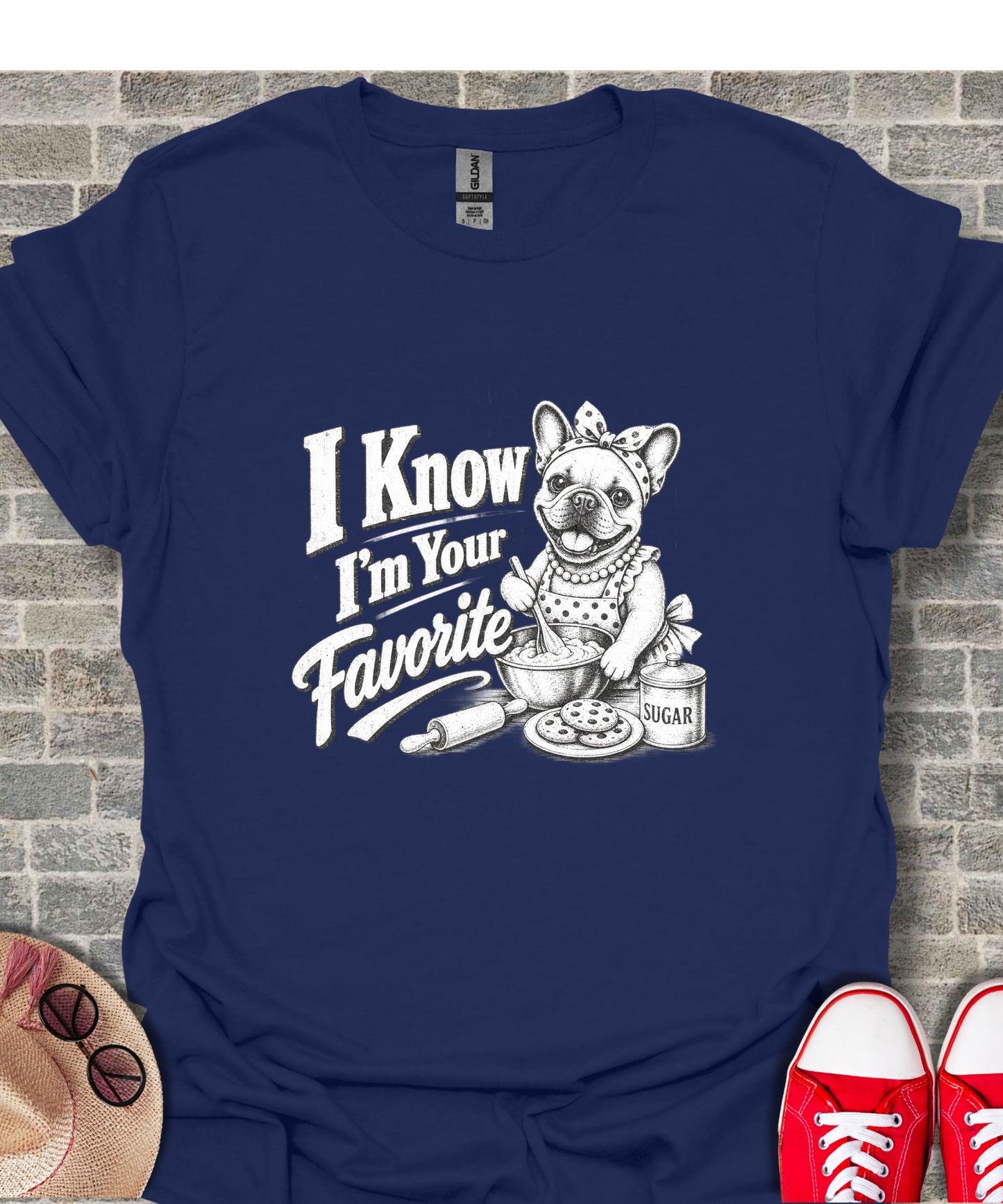 French bulldog in apron bakes, "I Know I'm Your Favorite" text.