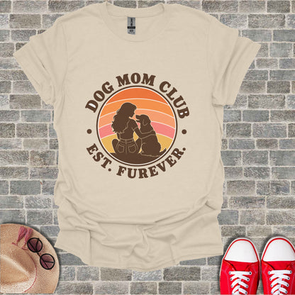 Cream t-shirt with "Dog Mom Club Est. Furever" graphic featuring a woman and dog.