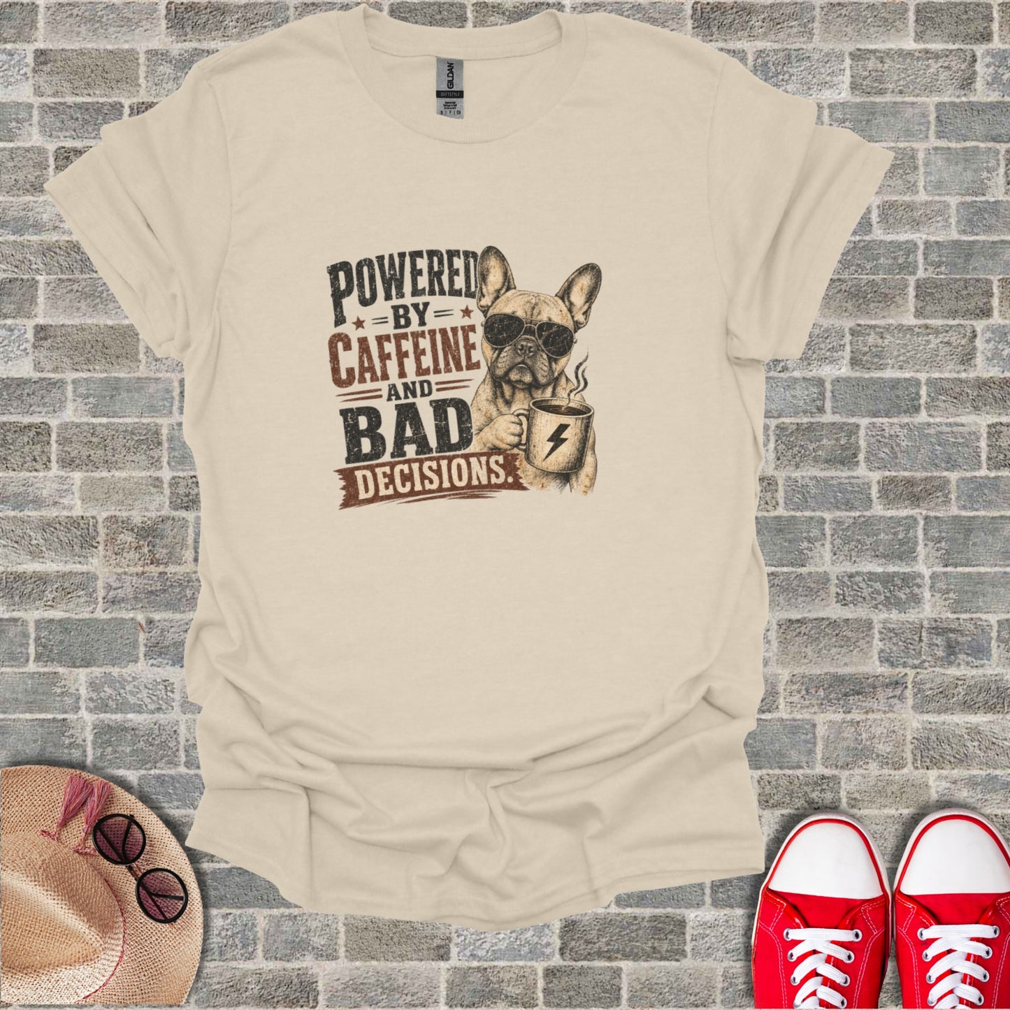 French Bulldog wearing sunglasses holding a coffee cup, text "Powered by Caffeine and Bad Decisions".
