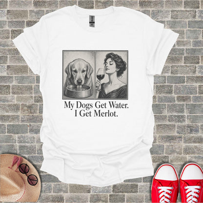 White t-shirt with graphic of dog and woman drinking wine, text "My Dogs Get Water. I Get Merlot."