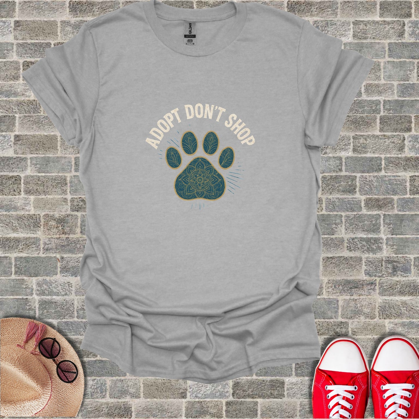 Gray t-shirt with "Adopt Don't Shop" and paw print design.