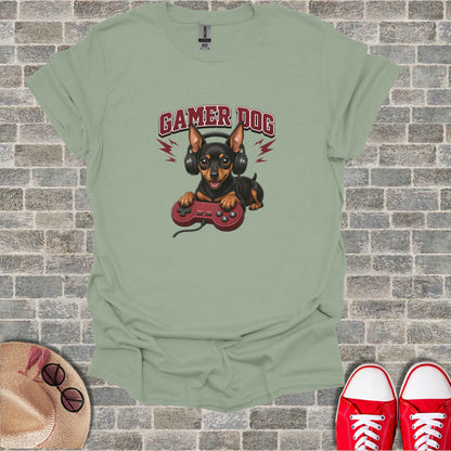 Dog wearing headphones holding video game controller, text "GAMER DOG".