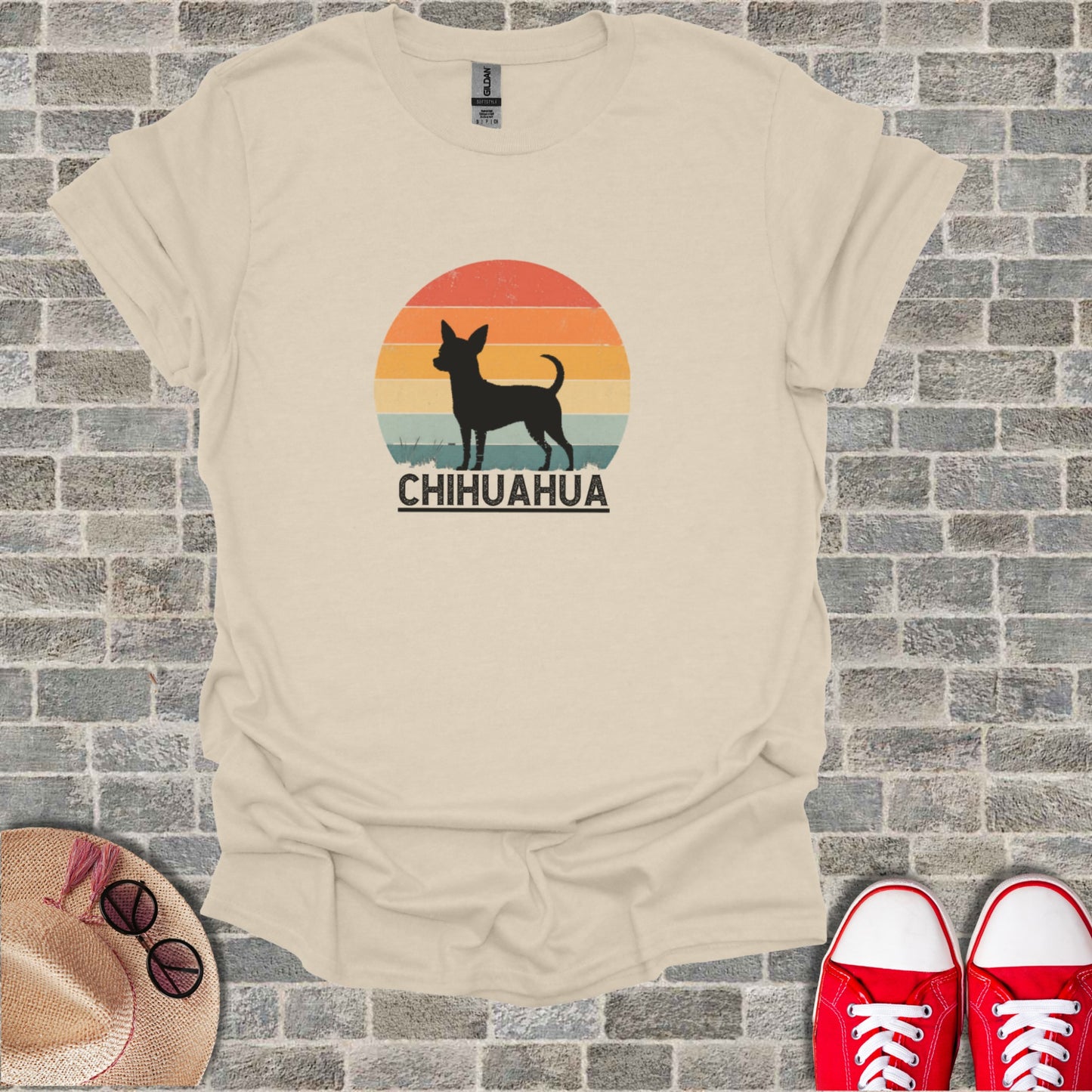 T-shirt graphic featuring a silhouette of a Chihuahua against a sunset and text.