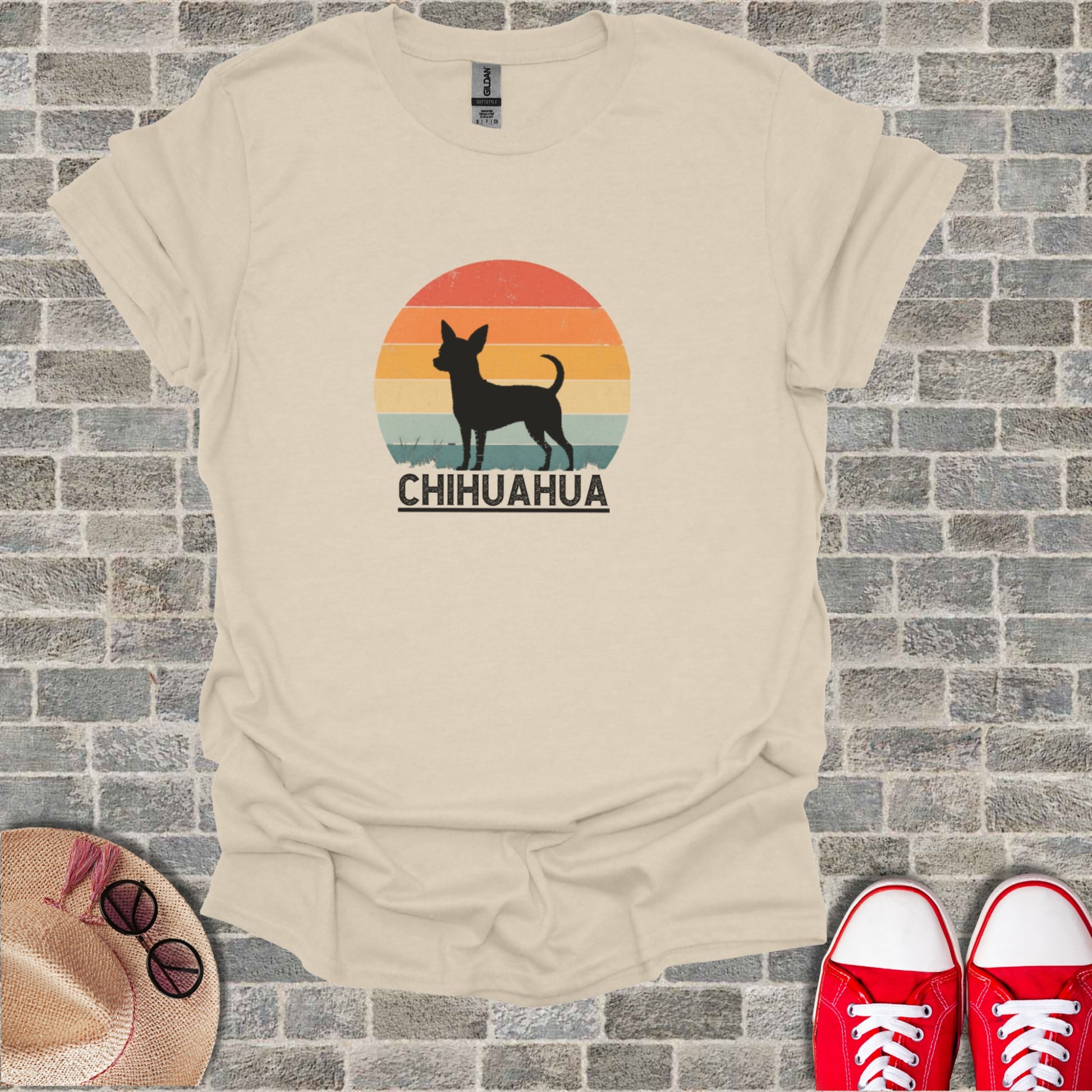 T-shirt graphic featuring a silhouette of a Chihuahua against a sunset and text.