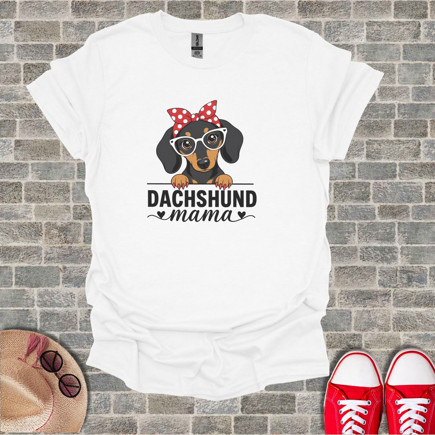 White t-shirt with "Dachshund mama" and a graphic of a dachshund wearing glasses and a bow.