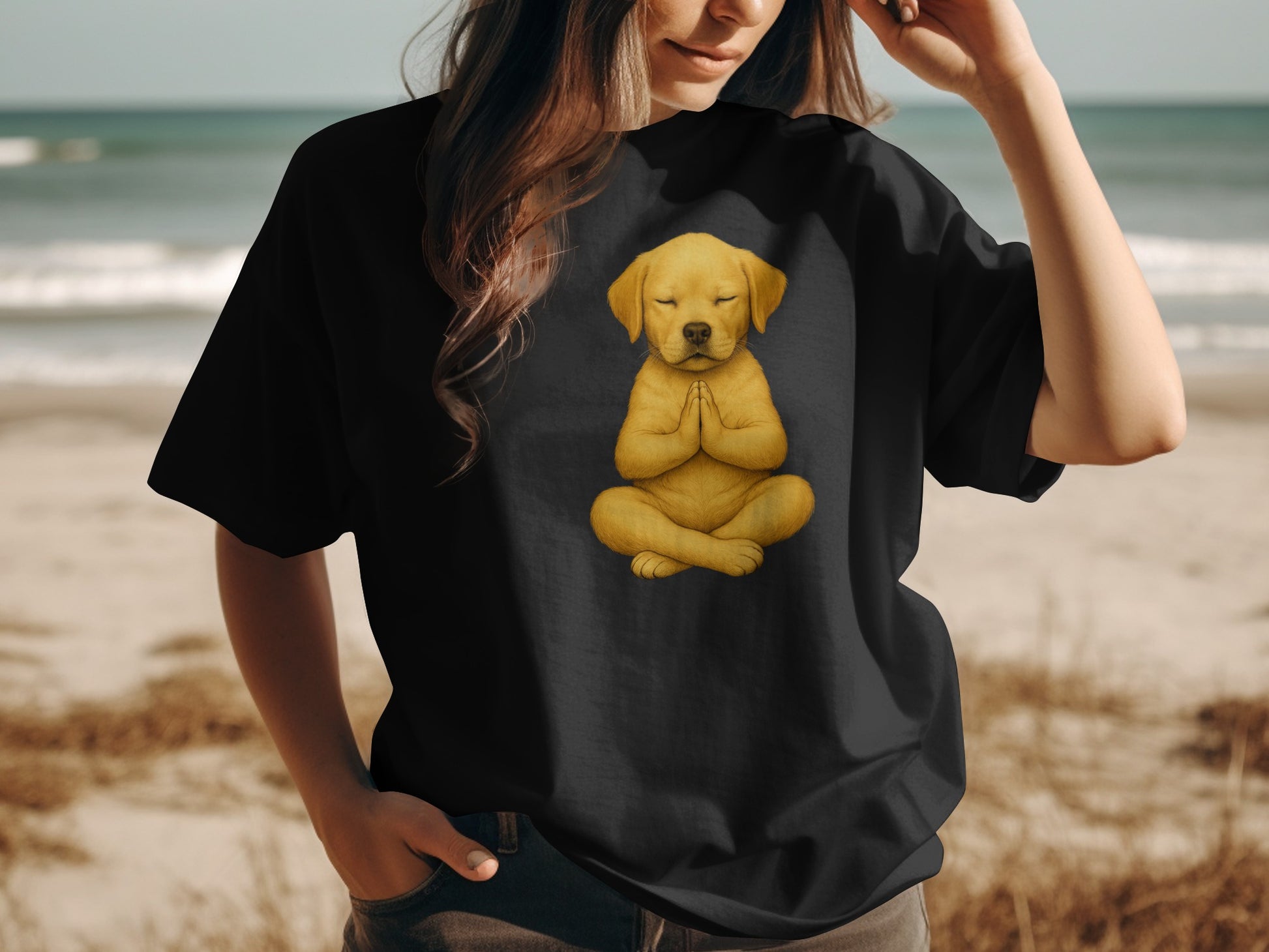 Black t-shirt with a golden retriever puppy meditating on a beach background.